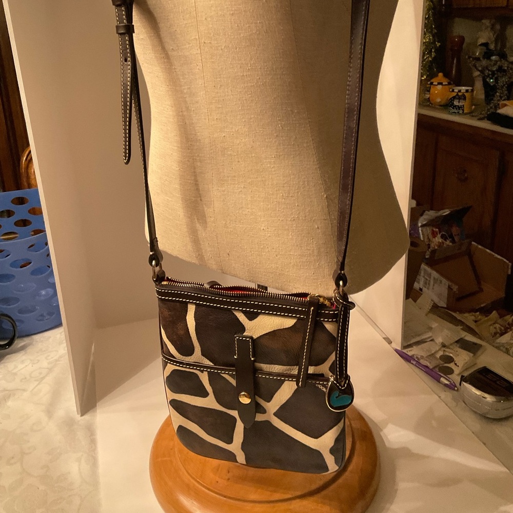 Dooney & Bourke giraffe print vinyl crossover bag.